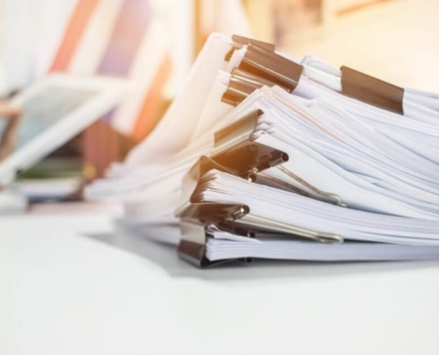 stack of papers with butterfly clip