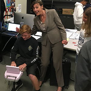 rosalie kramm poses with male student over steno machine. Veritext Inspires Future Reporters