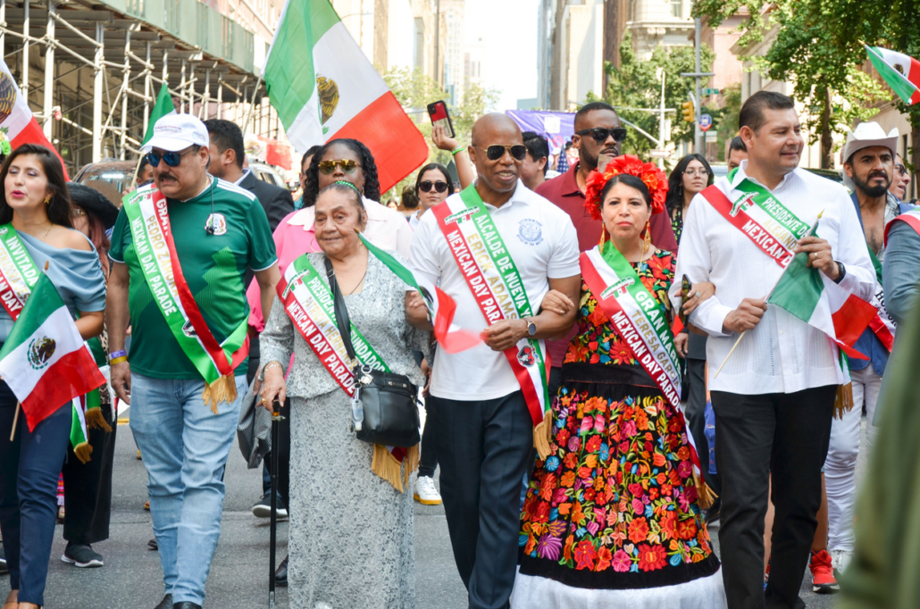 Group of people with flags marching during the Independence Day Parade in New York